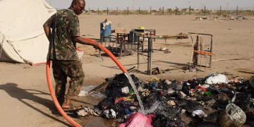 A soldier extinguishes a fire following a drone strike in Ad-Damar, Sudan, April 25, 2025.